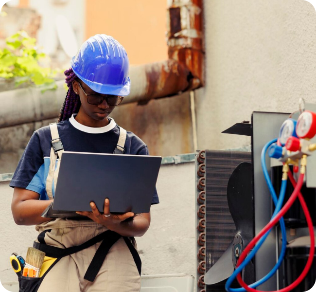 HVAC technician reviewing AC diagnostic results on a laptop