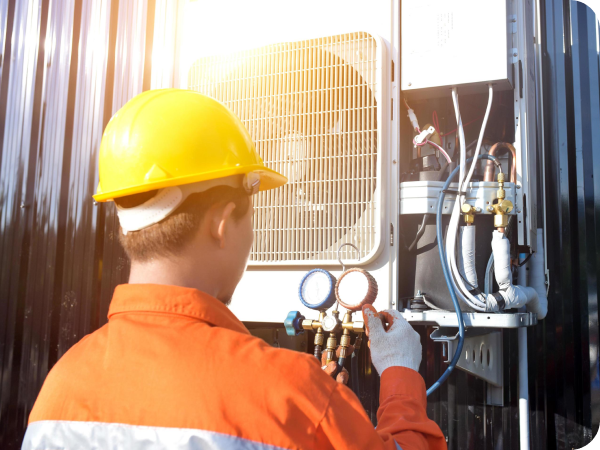 Technician checking refrigerant with gauges during an AC repair visit