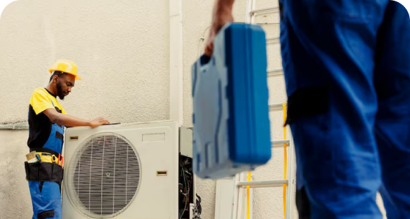 HVAC technicians performing AC service on an outdoor condenser