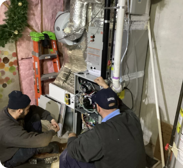 Caron technicians installing a high-efficiency furnace in a Merrimack Valley home