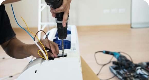Technician repairing a ductless mini-split indoor unit