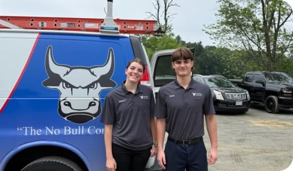 Two Caron Heating & Cooling team members with a Caron service van