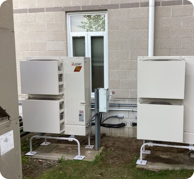 Mitsubishi heat pump units installed outside a Merrimack Valley building