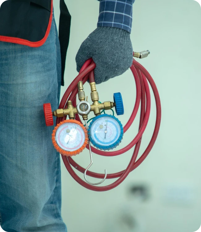 HVAC technician diagnosing a mini-split with refrigerant gauges