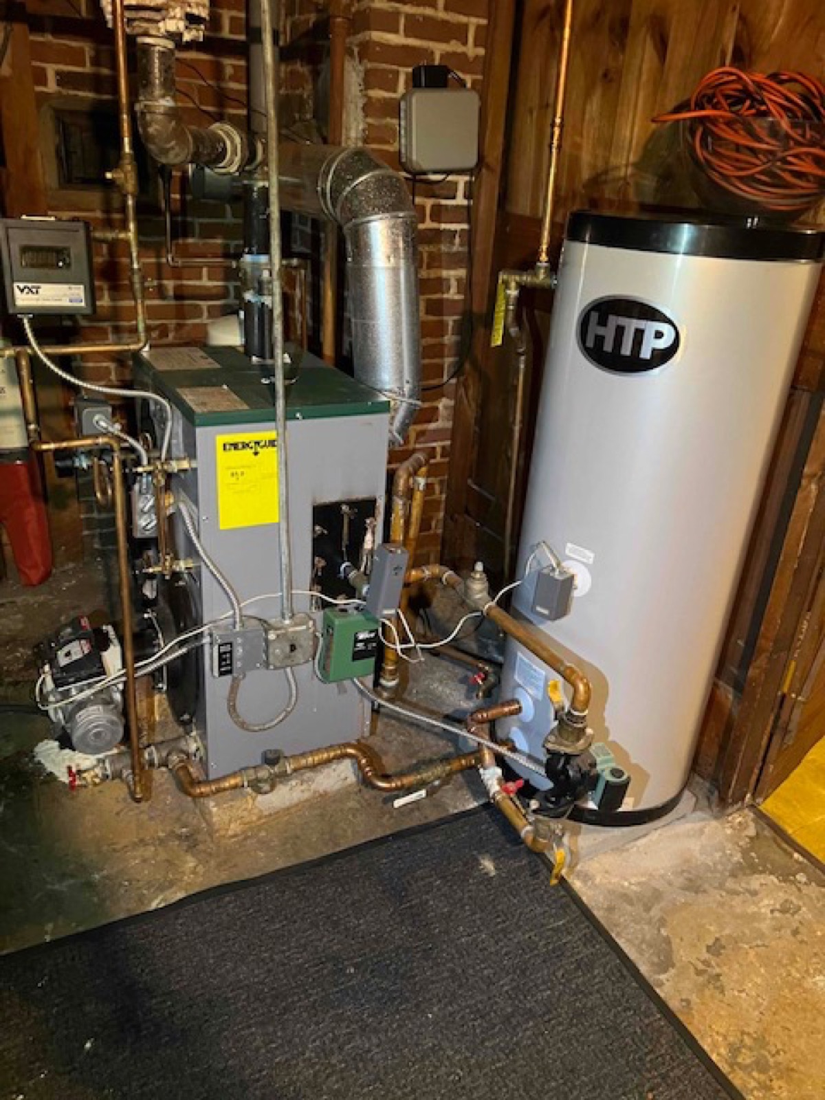 Cast-iron boiler and indirect-fired storage water heater installed by Caron Heating & Cooling in a Merrimack Valley basement