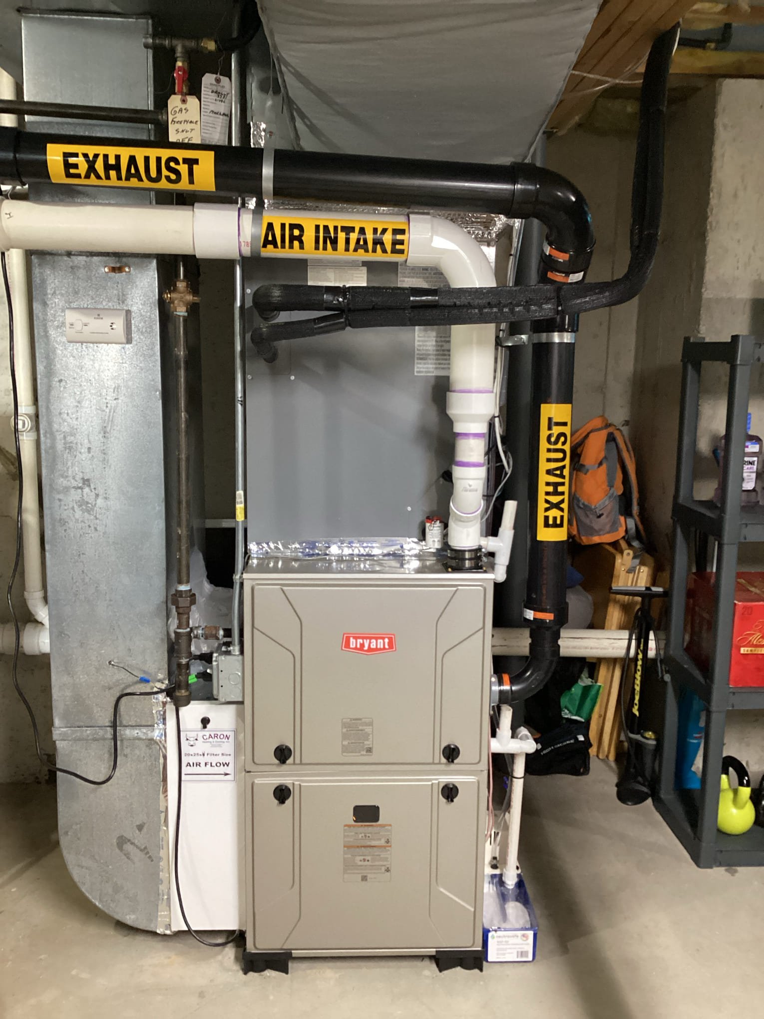 Bryant high-efficiency gas furnace with PVC venting installed by Caron Heating & Cooling in a Massachusetts basement
