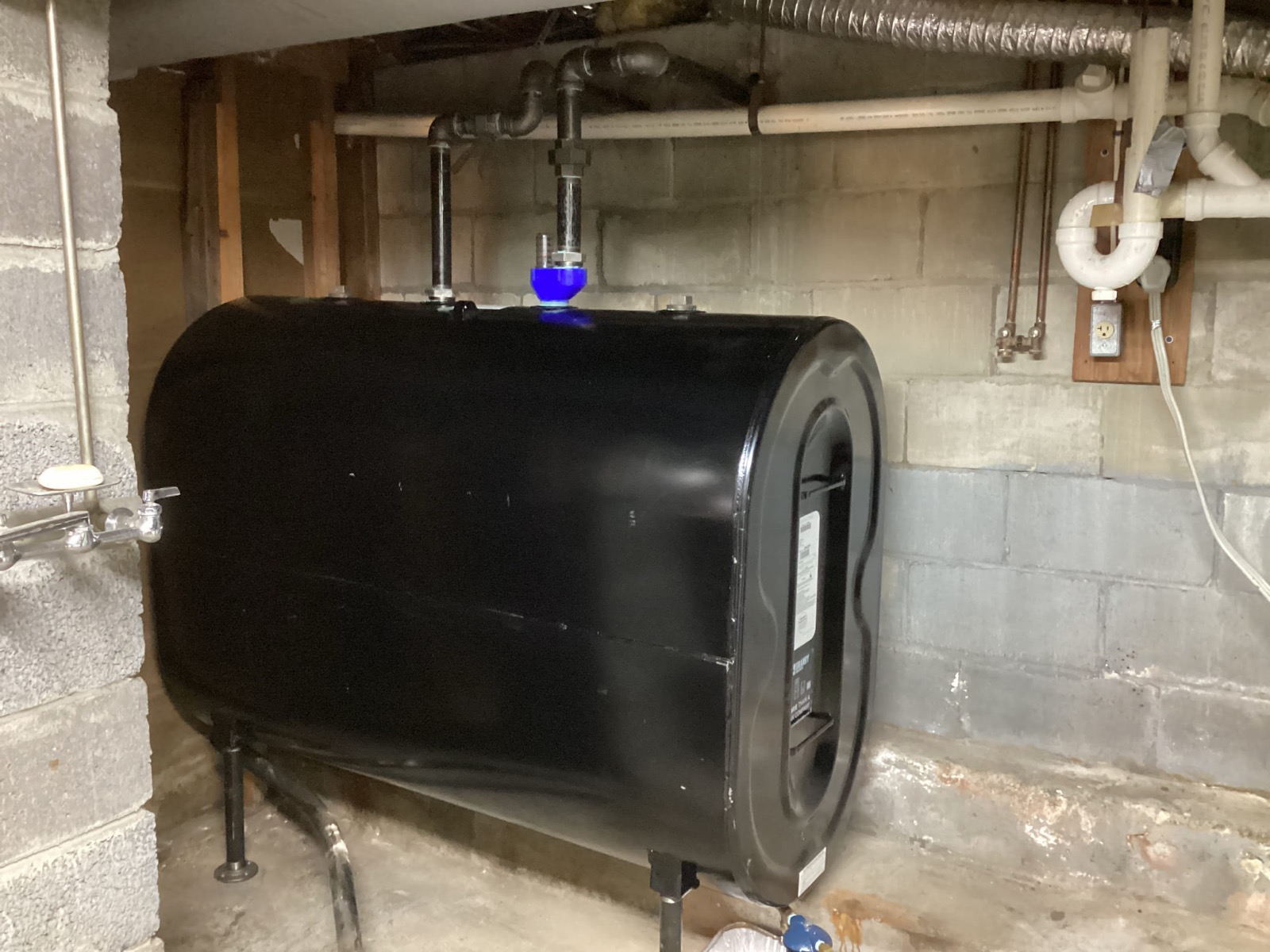 275-gallon heating oil tank installed by Caron Heating & Cooling in a Massachusetts basement