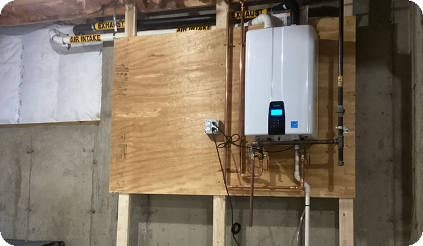 Navien tankless water heater installed on a basement wall by Caron Heating & Cooling